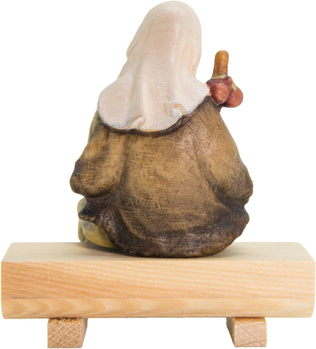 Berger avec moutons assis sur un rondin