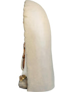 Lourdes with Bernadette in cave wood - color